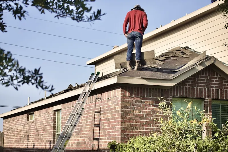 Professional roofer working on a residential roof in Ponderosa Gardens